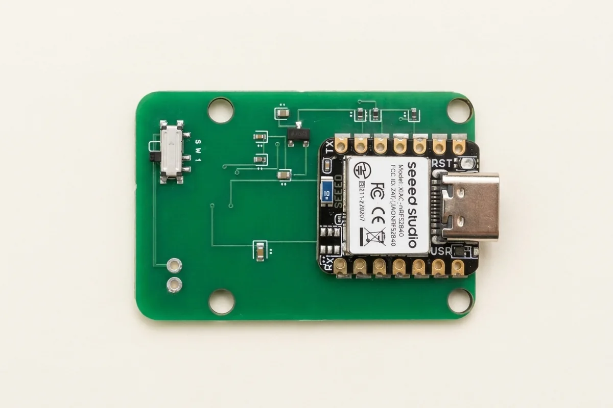 A small green circuit board with a XIAO nRF52840 module and a slide switch