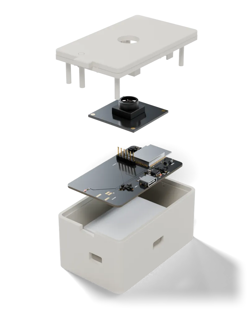 The Wi-Fi camera taken apart, top to bottom: the lid with its lens window, the camera module, the circuit board with its parts on, and the case
